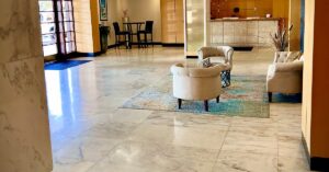 Commercial marble lobby floor in a Tampa hotel, reflective near the entrance and flat through the seating area